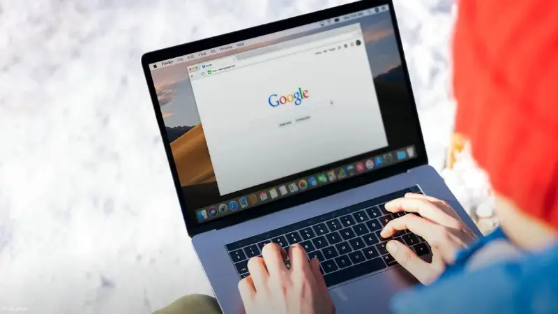 Individual typing on a laptop outdoors with snow, accessing the internet., tags: blue shield 4.7 million - pexel