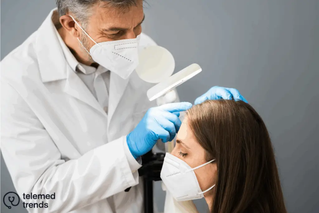 doctor inspecting women's scalp