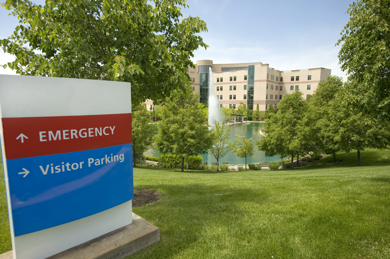 Emergency sign with rural hospital in background